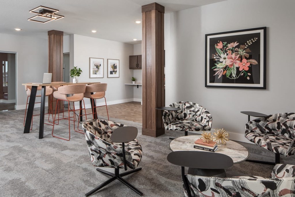 A living room with a grey carpet and a large painting on the wall.at The Edison at Maple Grove, Minnesota