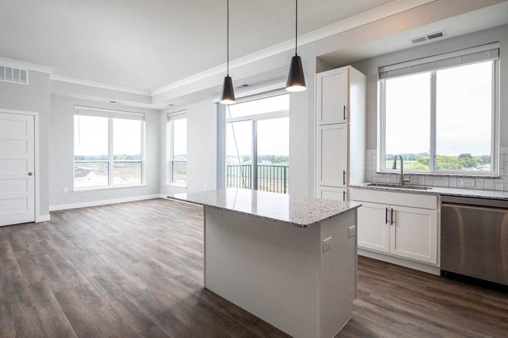 A kitchen with a large island in the middle.at The Edison at Maple Grove, Maple Grove, MN 55311