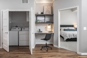 A small room with a bed, desk, and a cabinet.at The Edison at Maple Grove, Maple Grove, MN