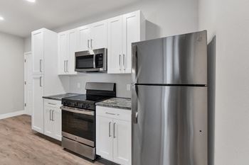 A modern kitchen with a stainless steel refrigerator.at The Edison at Maple Grove, Minnesota, 55311