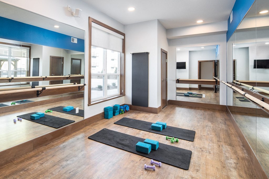 A yoga studio with mats and blocks on the floor at The Edison at Spirit, Shoreview