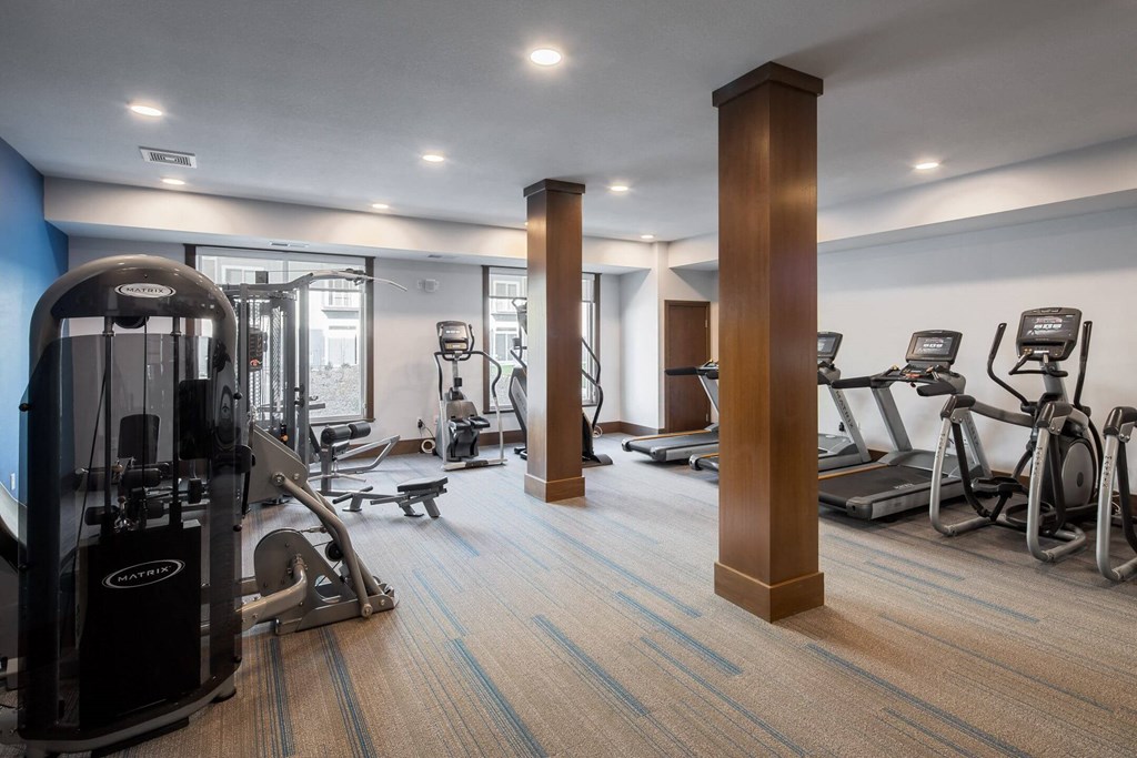 A gym with a variety of equipment including treadmills, weights, and exercise machines. A gym with a variety of equipment including treadmills, weights, and exercise machines at The Edison at Spirit, Lakeville, MN