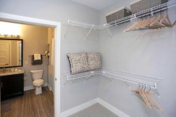 A bathroom with a toilet, sink, and a pillow on a shelf at The Edison at Spirit, Lakeville, 55044