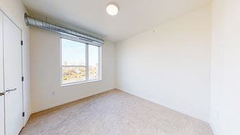 A room with a carpeted floor at The Bessemer at Seward Commons Apartments, Minneapolis, Minnesota
