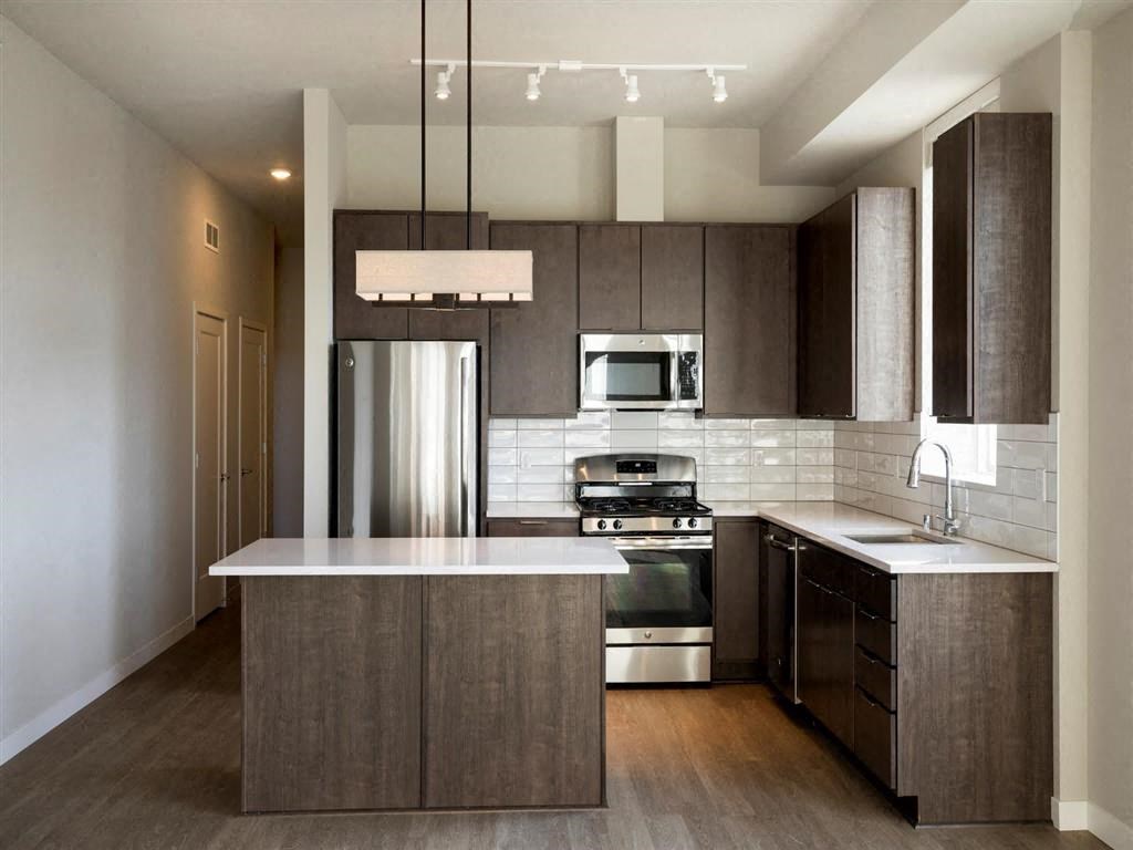 Kitchen with brown cabinets at The M on Hennepin, Minneapolis, MN, 55414