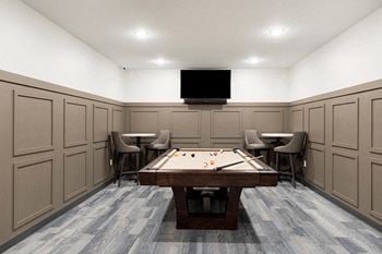 A room with a pool table and chairs at The Barnum Apartments, Minnesota