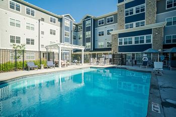 A large swimming pool in front of apartment buildings at The Barnum Apartments, White Bear Lake