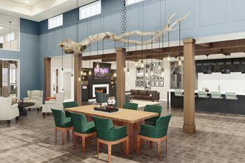 A dining room with a wooden table and green chairs at Lochner Apartments, White Bear Lake