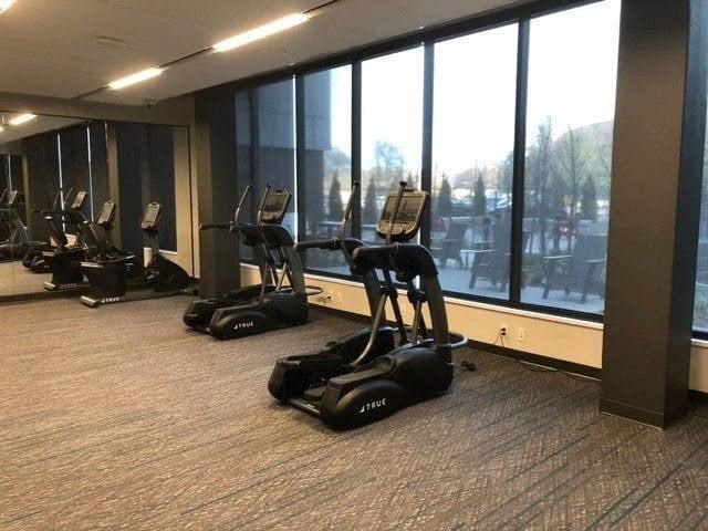 A gym with treadmills and elliptical machines.