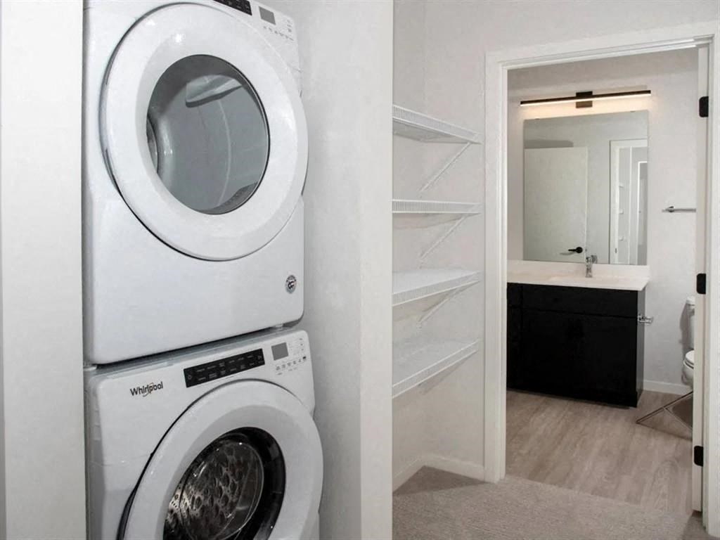 A white washing machine and dryer in a small laundry room.