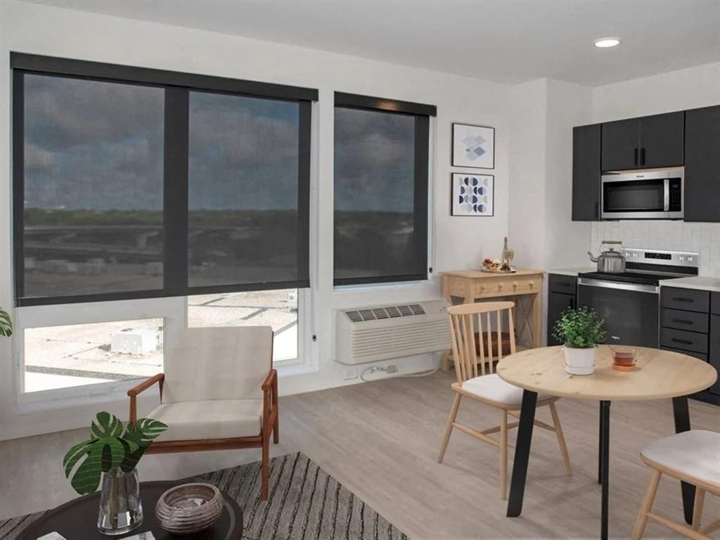 A modern kitchen with a dining table and chairs.