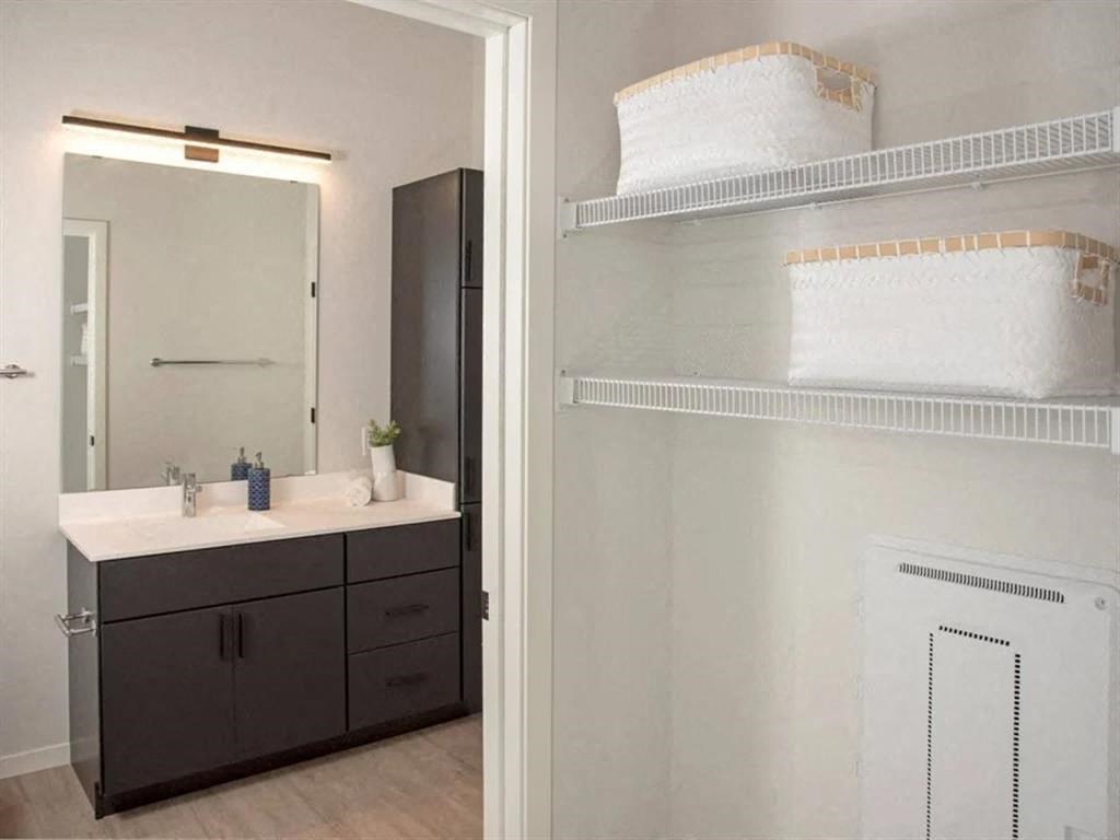A bathroom with a vanity and a medicine cabinet.