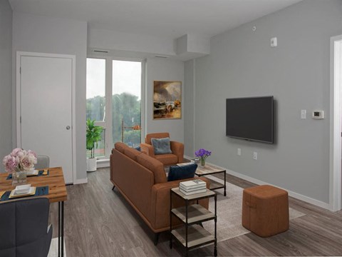 A living room with a brown couch, a coffee table, and a painting on the wall.