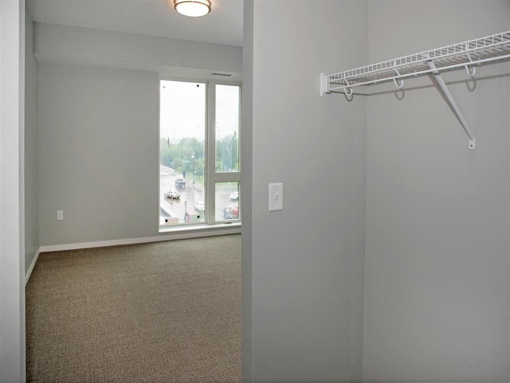 Empty room with a white wall and a white shelf.