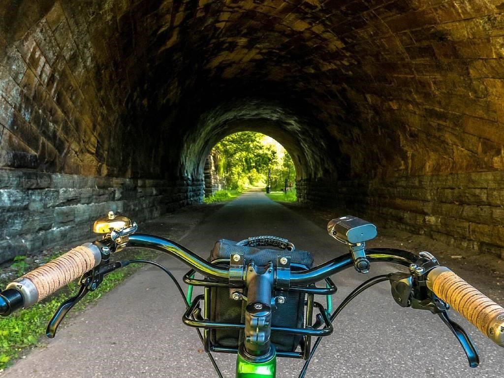 A bicycle is parked in a tunnel.