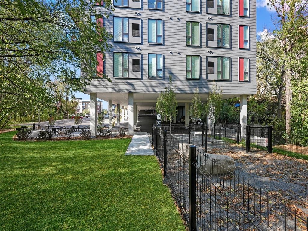 A modern building with a black fence in front.