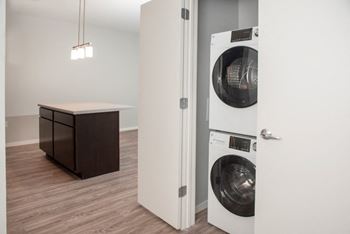 A white washing machine is in a doorway.