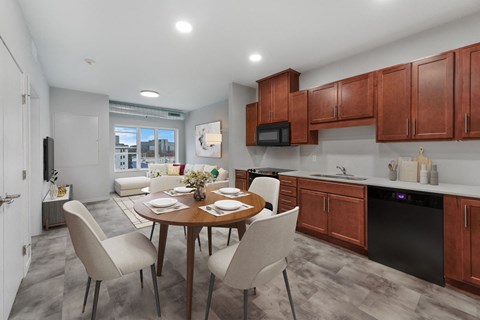 A modern kitchen with a dining table set for four.