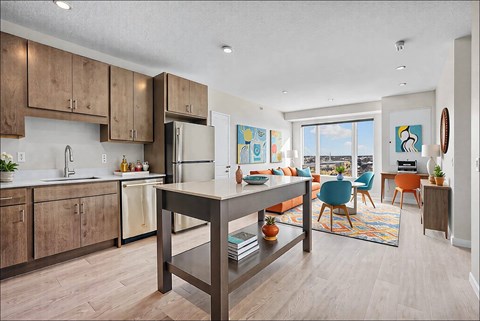 A kitchen with a table and chairs in front of a window.