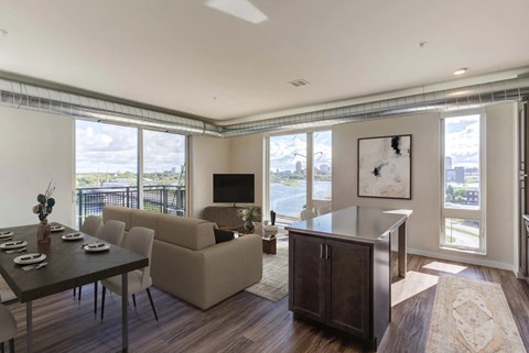 A modern living room with a dining table and chairs.