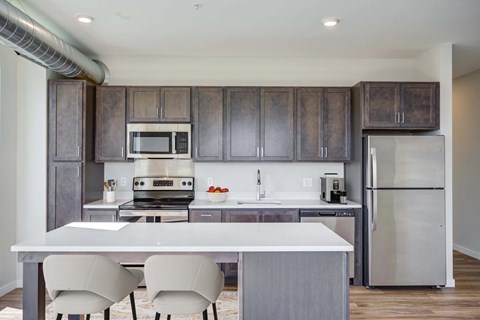 A modern kitchen with a white table and chairs.