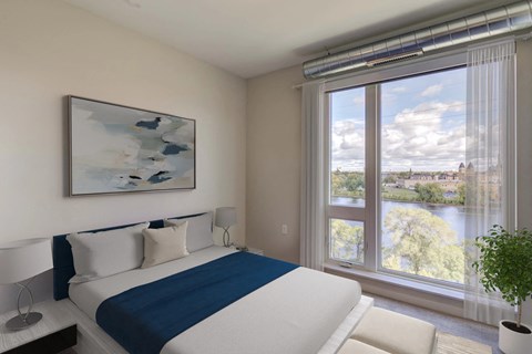 A Bedroom with a View of the City at Peregrine Apartments, Minneapolis, Minnesota