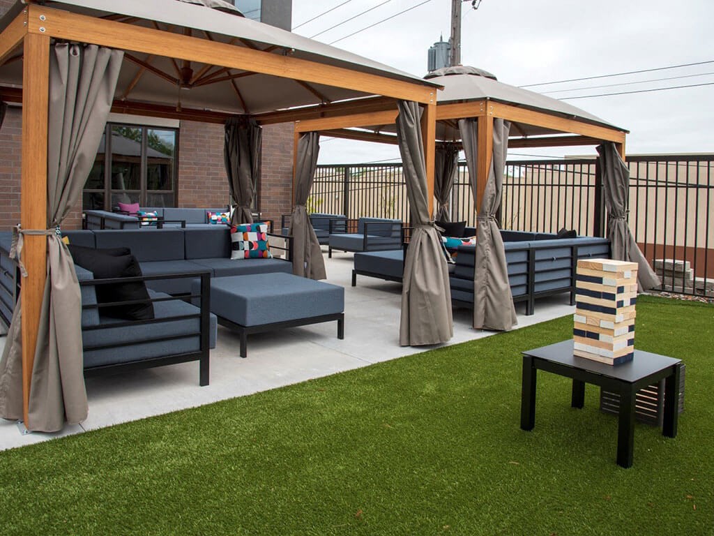 UPII outdoor lounge seating with oversized outdoor jenga and cabanas at Urban Park I and II Apartments, St Louis Park