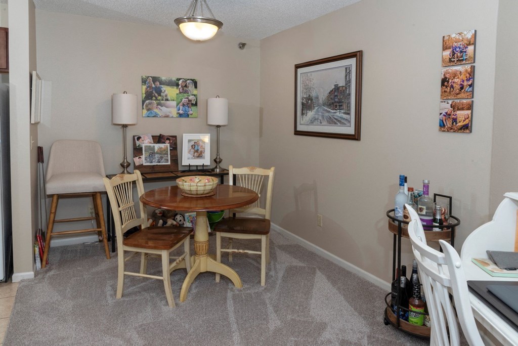 a dining room with a table and chairs and a window