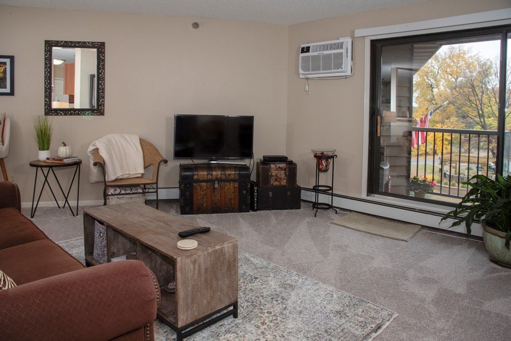 a white bedroom with a large bed and a window