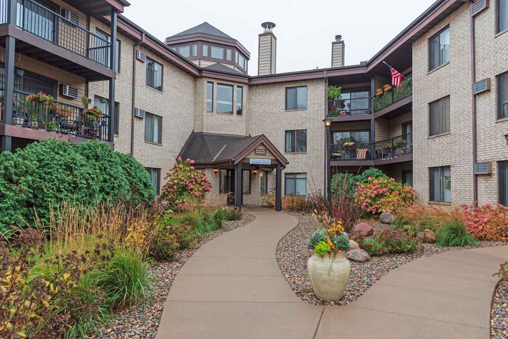 building entrance with lush landscaping