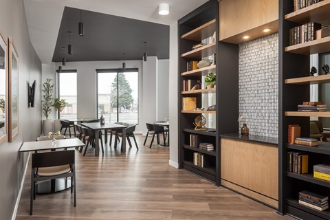 A modern dining room with a long table and chairs.