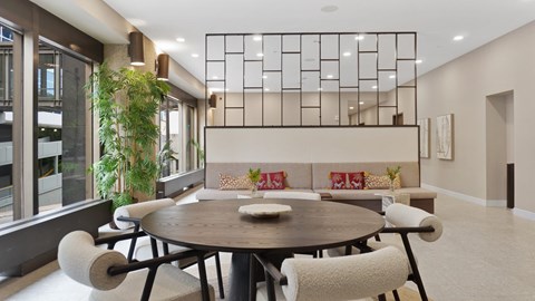 A modern dining room with a round table and chairs.