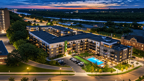 A large building with a pool in the middle of a parking lot.