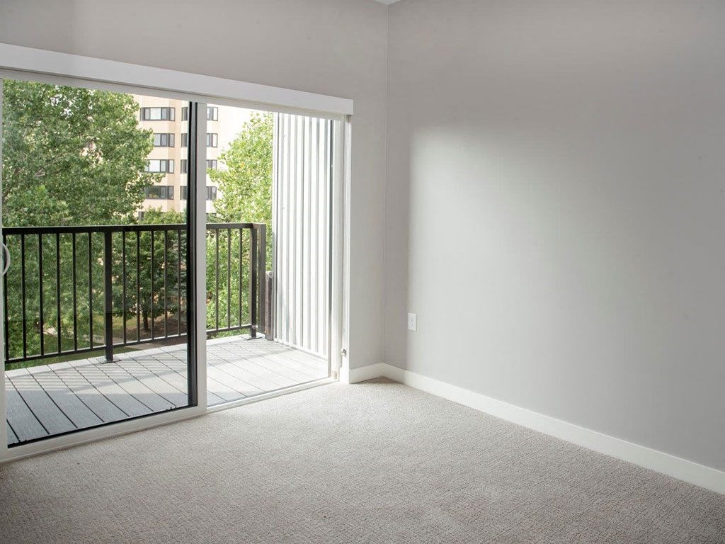 Nordic bedroom with tv wall and balcony at Urban Park I and II Apartments, St Louis Park, 55426