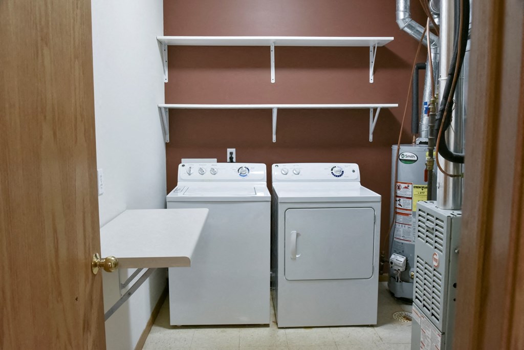 Laundry room with full size washer and dryer and shelving