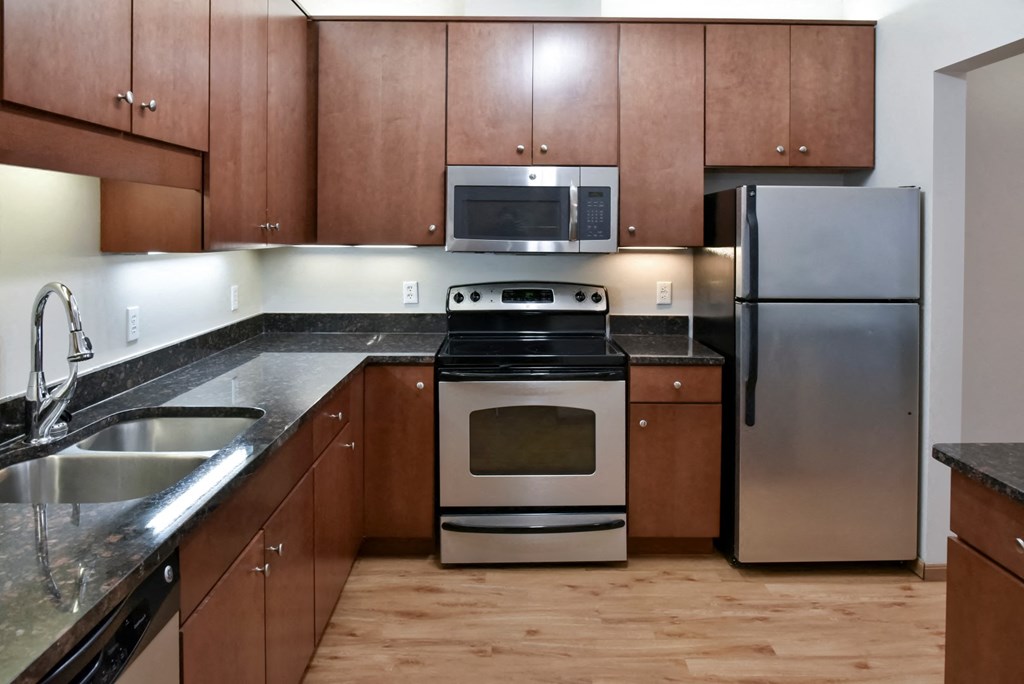 traditional kitchen with cherry cabinets and dark granite countertops