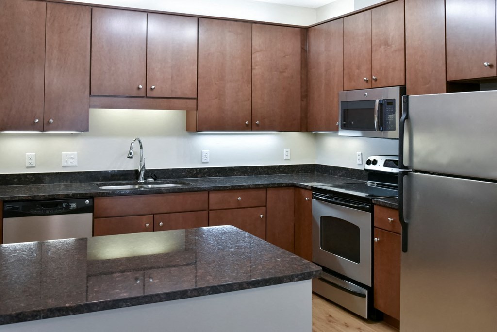 traditional kitchen with cherry cabinets and dark granite countertop