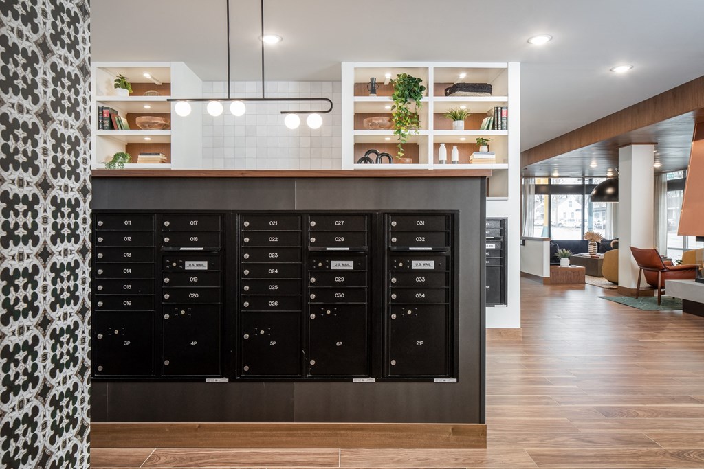a view of the mail room with a large collection of mailboxes