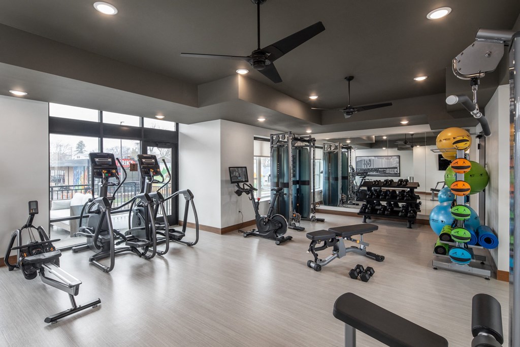 a gym with cardio equipment and weights