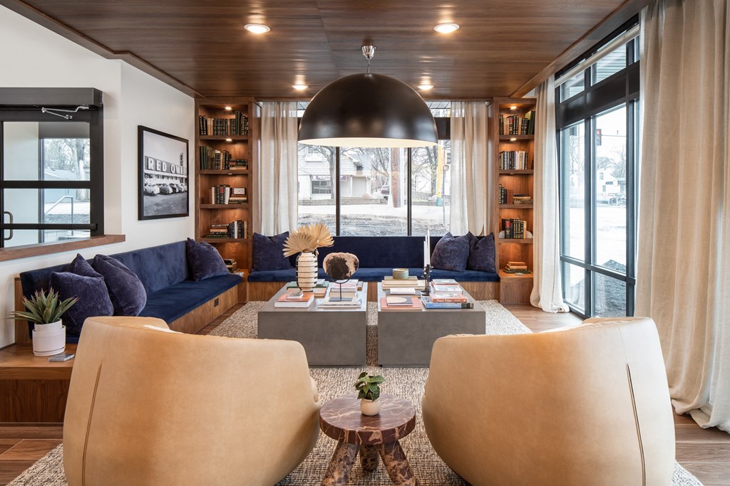 a living room filled with furniture and a large window