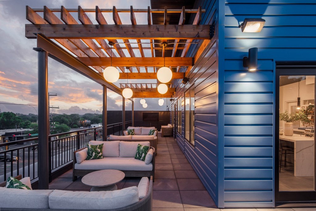 a balcony with couches and a table