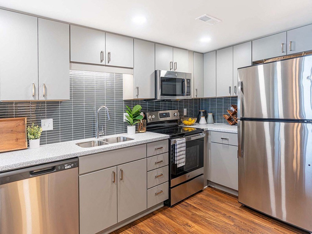 a kitchen with stainless steel appliances and white cabinets
