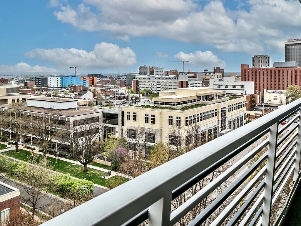 a view of the city from a balcony on a sunny day