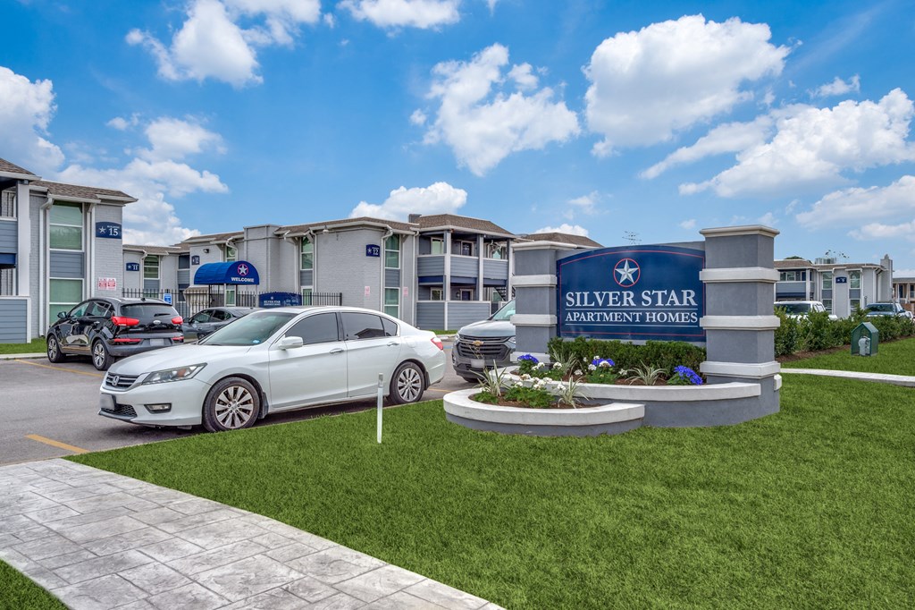 a car parked in front of a building with a sign for silver star apartments