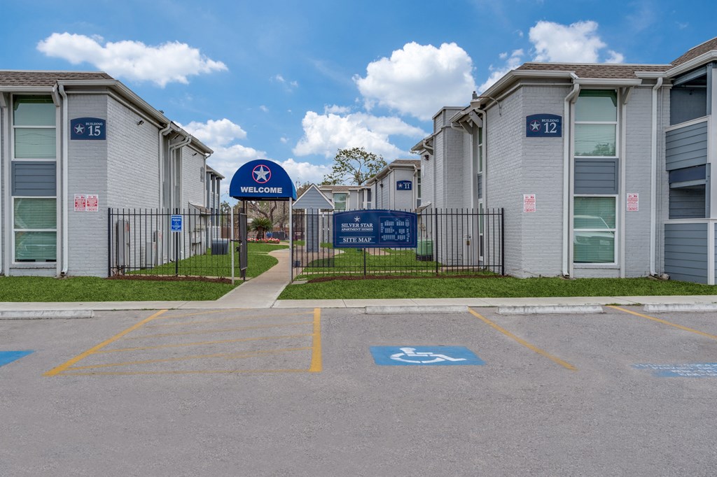 an empty parking lot in front of an apartment building