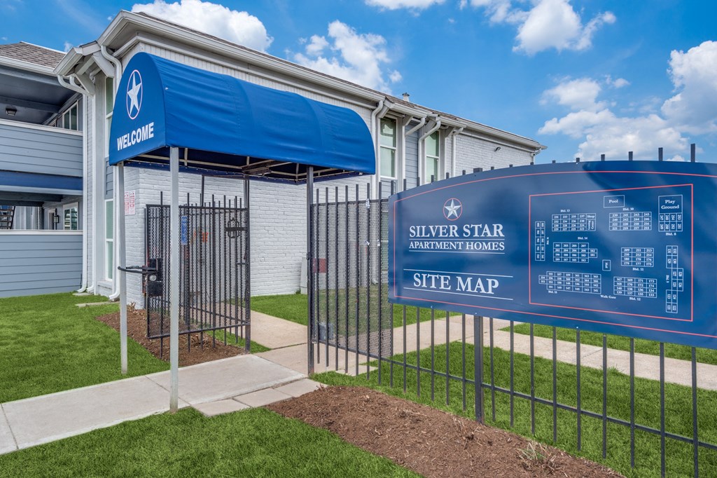 a blue site map sign in front of a building