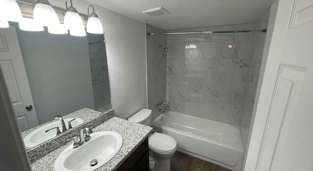 a bathroom with a sink toilet and a tub