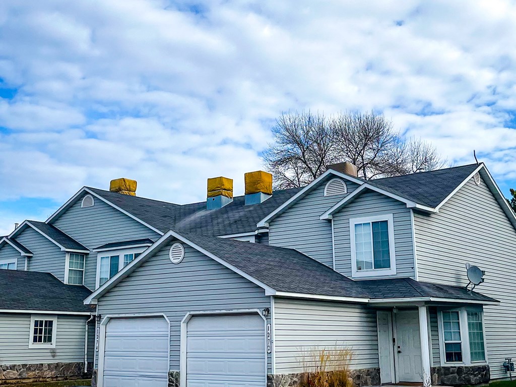 a house with two chimneys on the roof