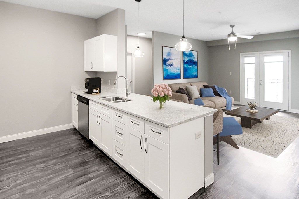 a kitchen and living room with a white counter top