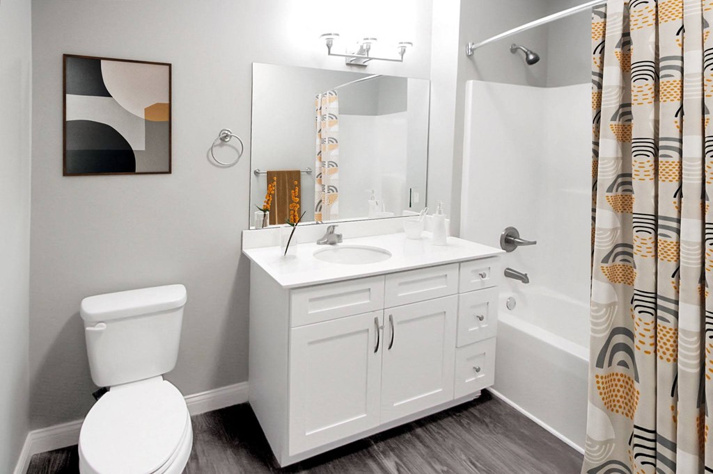 a bathroom with a white sink and a shower and a toilet